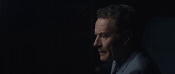 Movie still from “Wakefield” (2016), directed by Robin Swicord – A person wearing a suit and tie; Close Up shot, Over the shoulder angle