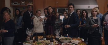 Movie still from “Wakefield” (2016), directed by Robin Swicord – A group of people standing around a table with wine glasses; Medium shot, High angle