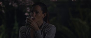 Movie still from “Wakefield” (2016), directed by Robin Swicord – A woman is drinking a cup of coffee; Medium shot, Over the shoulder angle