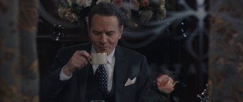 Movie still from “Wakefield” (2016), directed by Robin Swicord – A man wearing a suit and tie eating a piece of cake; Close Up shot, Over the shoulder angle