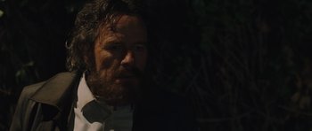 Movie still from “Wakefield” (2016), directed by Robin Swicord – A man with a beard wearing a suit and tie; Close Up shot, Over the shoulder angle