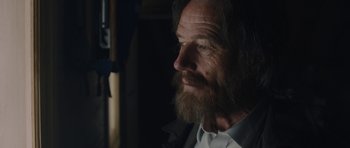 Movie still from “Wakefield” (2016), directed by Robin Swicord – A man with long hair and a long beard looking to his left; Close Up shot, Low angle