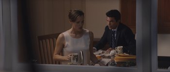 Movie still from “Wakefield” (2016), directed by Robin Swicord – A man and a woman sitting at a dinner table; Medium shot, Over the shoulder angle