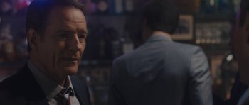 Movie still from “Wakefield” (2016), directed by Robin Swicord – A man in a suit and tie standing next to another man in a suit and tie; Close Up shot, Over the shoulder angle