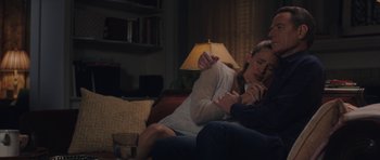Movie still from “Wakefield” (2016), directed by Robin Swicord – A man and a woman sitting on a couch together; Medium shot, High angle