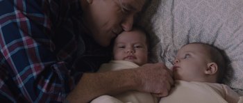 Movie still from “Wakefield” (2016), directed by Robin Swicord – An older man holding a baby in his arms; Close Up shot, Overhead angle