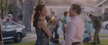 Movie still from “Wakefield” (2016), directed by Robin Swicord – A man and a woman are holding glasses of orange juice; Medium shot, Over the shoulder angle