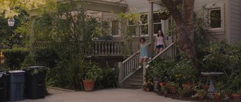 Movie still from “Wakefield” (2016), directed by Robin Swicord – Two young girls standing on the steps of a house; Wide shot, High angle