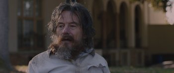 Movie still from “Wakefield” (2016), directed by Robin Swicord – A man with long hair and a long beard; Close Up shot, Over the shoulder angle