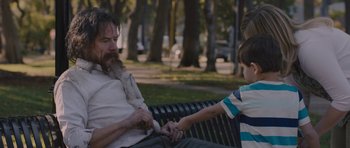 Movie still from “Wakefield” (2016), directed by Robin Swicord – A man sitting on top of a bench next to a boy; Medium shot, Over the shoulder angle