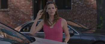 Movie still from “Wakefield” (2016), directed by Robin Swicord – A woman standing next to a car on a city street; Medium shot, Over the shoulder angle