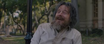 Movie still from “Wakefield” (2016), directed by Robin Swicord – An old man with long hair and a long beard; Medium shot, Over the shoulder angle