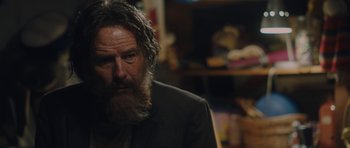 Movie still from “Wakefield” (2016), directed by Robin Swicord – An older man with a beard and a suit; Close Up shot, Over the shoulder angle
