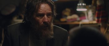 Movie still from “Wakefield” (2016), directed by Robin Swicord – A man with a long beard wearing a suit and tie; Close Up shot, Over the shoulder angle