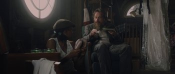 Movie still from “Wakefield” (2016), directed by Robin Swicord – A man sitting on a couch while a woman sits next to him; Medium shot, Over the shoulder angle