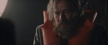 Movie still from “Wakefield” (2016), directed by Robin Swicord – An old man with a beard wearing a life jacket; Close Up shot, Over the shoulder angle