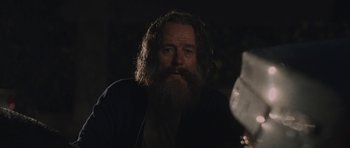 Movie still from “Wakefield” (2016), directed by Robin Swicord – A man with a long beard is looking at the camera; Close Up shot, Over the shoulder angle