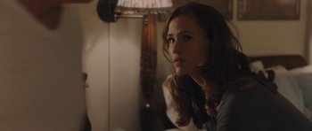 Movie still from “Wakefield” (2016), directed by Robin Swicord – A woman sitting in front of a lamp in a dimly - lit room; Close Up shot, Over the shoulder angle