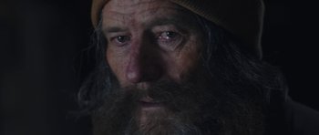 Movie still from “Wakefield” (2016), directed by Robin Swicord – An old man with long grey hair and a beard; Extreme Close Up shot, Over the shoulder angle