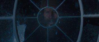 Movie still from “Wakefield” (2016), directed by Robin Swicord – A man with a beard is looking through a window at night; Extreme Close Up shot, Over the shoulder angle