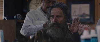Movie still from “Wakefield” (2016), directed by Robin Swicord – A man with long hair is getting his hair cut; Close Up shot, Over the shoulder angle
