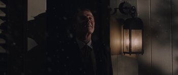 Movie still from “Wakefield” (2016), directed by Robin Swicord – A man wearing a suit and a red neck tie; Medium shot, Low angle