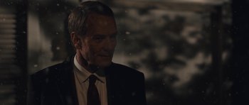 Movie still from “Wakefield” (2016), directed by Robin Swicord – An older man wearing a suit and tie; Close Up shot, Over the shoulder angle