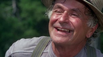 Movie still from “Walking Tall” (1973), directed by Phil Karlson – An older man wearing a hat smiling for the camera; Close Up shot, Low angle