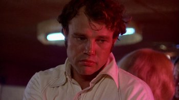 Movie still from “Walking Tall” (1973), directed by Phil Karlson – A person wearing a white shirt; Close Up shot, Low angle