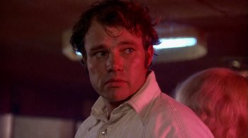 Movie still from “Walking Tall” (1973), directed by Phil Karlson – A person wearing a white shirt; Close Up shot, Low angle