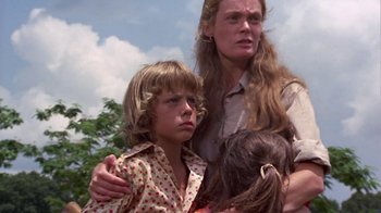 Movie still from “Walking Tall” (1973), directed by Phil Karlson – A woman and two children standing next to each other; Close Up shot, Low angle