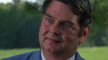 Movie still from “Walking Tall” (1973), directed by Phil Karlson – A person wearing a suit and tie; Close Up shot, Over the shoulder angle