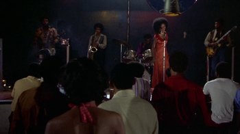 Movie still from “Walking Tall” (1973), directed by Phil Karlson – A group of people in a room with a microphone; Wide shot, Low angle