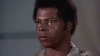 Movie still from “Walking Tall” (1973), directed by Phil Karlson – A person wearing a shirt; Close Up shot, Low angle