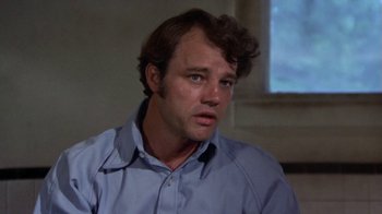 Movie still from “Walking Tall” (1973), directed by Phil Karlson – A person wearing a blue shirt; Close Up shot, High angle