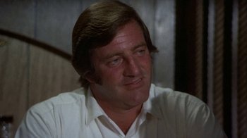 Movie still from “Walking Tall” (1973), directed by Phil Karlson – A person wearing a white shirt; Close Up shot, Low angle