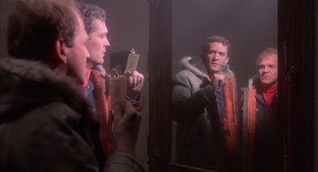Movie still from “WarGames” (1983), directed by John Badham – A man taking a picture of himself in the mirror; Close Up shot, Low angle