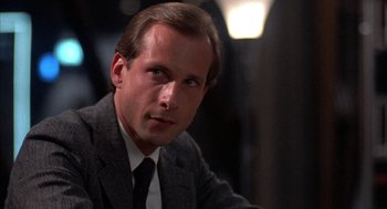 Movie still from “WarGames” (1983), directed by John Badham – A person wearing a suit and tie; Close Up shot, Low angle