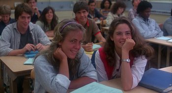 Movie still from “WarGames” (1983), directed by John Badham – A group of people sitting at a table in a classroom; Medium shot, Low angle