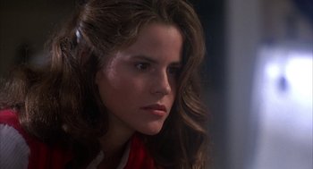 Movie still from “WarGames” (1983), directed by John Badham – A person with long brown hair; Close Up shot, Over the shoulder angle