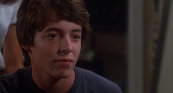 Movie still from “WarGames” (1983), directed by John Badham – A young man with brown eyes stares into the distance; Close Up shot, Over the shoulder angle