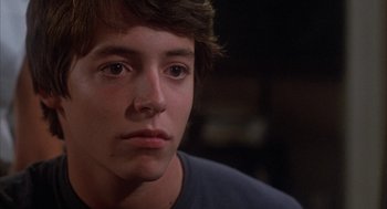 Movie still from “WarGames” (1983), directed by John Badham – A young man's face in a dark room; Close Up shot, Over the shoulder angle