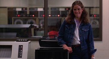 Movie still from “WarGames” (1983), directed by John Badham – A woman standing in front of an oven in a room; Medium shot, Low angle