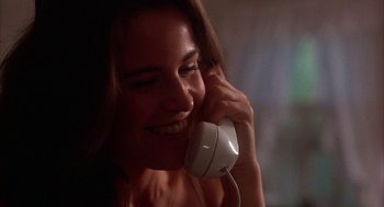 Movie still from “WarGames” (1983), directed by John Badham – A woman talking on a phone while sitting down; Close Up shot, Low angle