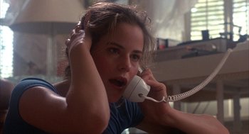 Movie still from “WarGames” (1983), directed by John Badham – A woman holding a phone up to her ear; Close Up shot, Low angle