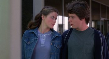 Movie still from “WarGames” (1983), directed by John Badham – A man and a woman standing next to each other; Close Up shot, Over the shoulder angle