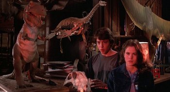 Movie still from “WarGames” (1983), directed by John Badham – Two people standing next to each other in a room; Medium shot, Low angle