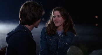 Movie still from “WarGames” (1983), directed by John Badham – A young man and a young woman talking to each other; Medium shot, Over the shoulder angle