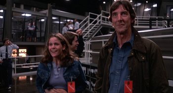 Movie still from “WarGames” (1983), directed by John Badham – A man and a woman standing next to each other; Medium shot, Low angle
