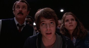 Movie still from “WarGames” (1983), directed by John Badham – A young man looking up at the ceiling of an auditorium; Close Up shot, Low angle
